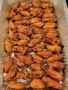 chicken wings in a glass dish on a table