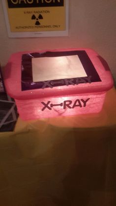 a pink box with the word x - ray on it sitting on top of a table