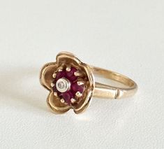 Vintage 14K Solid Yellow Gold Rubies & Diamond Flower Band Ladies Ring Size 5 Lovely vintage ring features a bezel set diamond surrounded by 5 rubies, all set in solid gold in a flower shape. Front measurements: 13 x 13mm Weight: 4.6 grams Signed: 14K  Very good vintage pre-owned condition. Also comes with a gift box. Free, fast shipping! Ships out the same or next business day. Flower Band, Earth Goddess, Ladies Ring, Rings Diamond, Bezel Set Diamond, Diamond Flower, Ruby Diamond, Vintage Ring, Solid Yellow