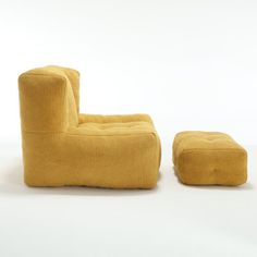 a yellow chair and footstool sitting next to each other on a white surface