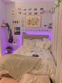 a bed room with a neatly made bed and purple lights on the wall above it