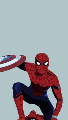 the spider - man is squatting down with his arm extended and holding a shield