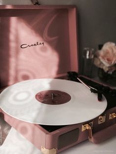 a record player sitting on top of a suitcase