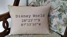 a pillow that is on top of a chair with the words disney world printed on it