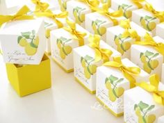 small boxes with yellow ribbons and tags on them are lined up in the shape of lemons