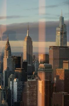 the city skyline is seen through a window