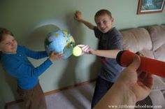 two children are playing with a ball and tennis racket