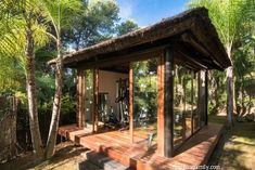 a wooden gazebo surrounded by palm trees