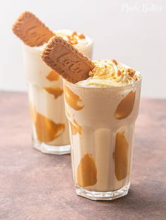 two glasses filled with ice cream and cinnamon sticks