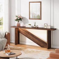 a living room filled with furniture and a mirror on top of a table next to a couch