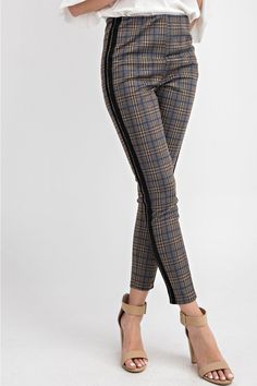 The Plaid Me Up ponte skinny pants/leggings are a classic with a twist that are so easy to wear with a stretchy waistband. The black racer stripe up the side of the leg adds a fun twist to a classic plaid. We love this styled with our Sophie turtleneck tunic or the Mia cowl neck. Offered in Olive 97% polyester, 3% spandex Imported Model is 5'8" and wearing a small Recommend to size up for a not so skinny fit Olive color option has the blue stripe detail Ash gray color option has the pink stripe Denim Cargos, Plaid Pants Outfit, 60’s Fashion, Plaid Pants Women, Winter Pants Outfit, Turtleneck Tunic, Black Racer, Ponte Leggings, Denim Cargo