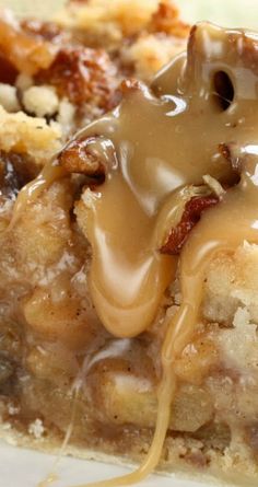 a close up of a slice of pie with caramel sauce and nuts on top