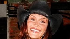 a woman wearing a cowboy hat and smiling