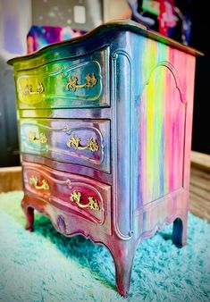 a multicolored dresser sitting on top of a blue rug