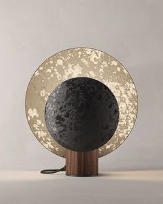 a black and white table lamp sitting on top of a wooden base