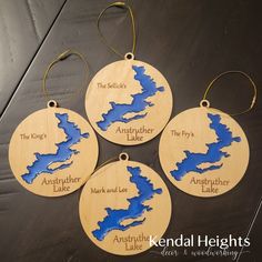 four wooden ornament ornaments with lake names on them