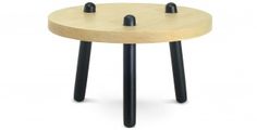 a small wooden table with three black legs