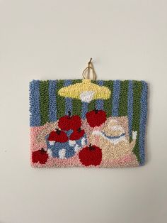 a rug hanging on the wall with an umbrella