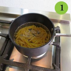 a pan filled with food sitting on top of a stove next to a burner