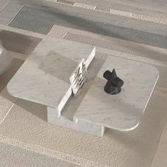 a white marble coffee table sitting on top of a floor