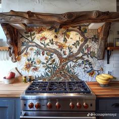 a stove top oven sitting inside of a kitchen next to a wooden countertop with fruit on it