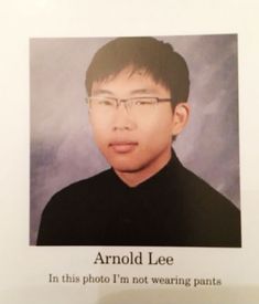 a man with glasses and a black shirt in front of a sign that says, arroll lee in this photo i'm not wearing pants