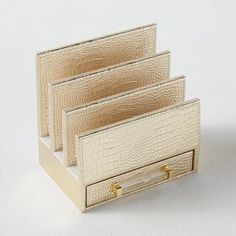 three pieces of gold crocodile skin are stacked on top of each other