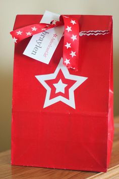 a red paper bag with white stars on it