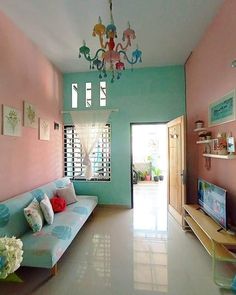 a living room filled with furniture and a chandelier hanging over the top of it