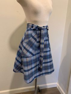 1970's Vintage Wrap Around Skirt ~ Navy Blue Vintage Plaid Print Skirt, Very Good Condition The two last photo shows its small issues. I will be mailing it Priority Mail and First Class International. Measurements Adjustable Waist ~ 26 Inch Length ~ 22 Inch Retro Cotton Pleated Skort, Retro Pleated Cotton Skort, Retro Blue Fitted Skort, Blue Retro Cotton Skort, Retro Blue Cotton Skort, Retro Pleated Skort For School, Retro Blue Skort For Spring, High Waist Retro Pleated Skirt, Spring Retro Blue Skort