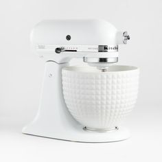 a white mixer sitting on top of a table