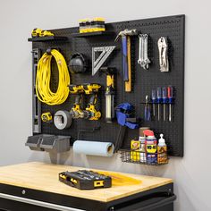 a workbench with tools hanging on the wall