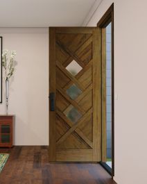 a wooden door in a white room with wood flooring and artwork on the wall