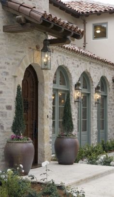 a house with two large planters in front of it