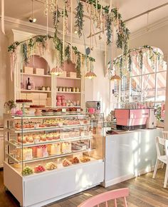 the inside of a bakery with lots of cakes and pastries