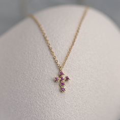 A dainty cross pendant with natural pink sapphire gemstones for women and girls. This small pendant is a great choice for a birthday gift for her. D E T A I L S ● Metal: 14K solid gold, 14K white gold  ● Gemstone: 16 Pink Sapphires, Round Cut, Natural ● Sapphires' Weight: 0.12 ct ● Length: 16 inches ● Cross dimensions: 13mm x 7mm H O W ∙ T O ∙ O R D E R Choose from the drop-down menu the available options (Metal) and leave us a note for any special requirements. G I F T S All our pieces are deli Jewelry Photography Tutorial, Dainty Cross Necklace, Small Crosses, Funky Jewelry, Jewelry Photography, Small Pendant, Dream Jewelry, Natural Sapphire, Sapphire Gemstone