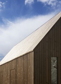 a wooden building with a clock on the side