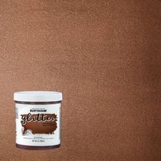 a can of glotter paint sitting on top of a wooden table next to a brown wall