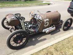 an antique car is parked on the side of the road