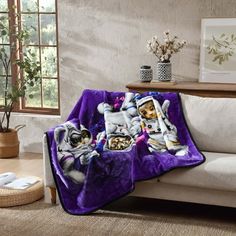 a couch with a purple blanket on top of it