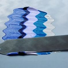 a blue and white striped knife sitting on top of a table