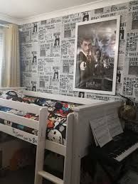 a bedroom with a bunk bed, piano and movie posters on the wall