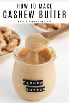 cashew butter being spooned into a jar with cashews in the background