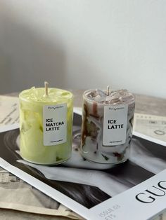 two candles sitting on top of a magazine next to each other with labels reading ice match latte