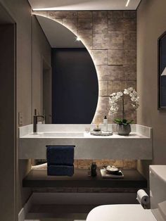 a white sink sitting under a mirror in a bathroom