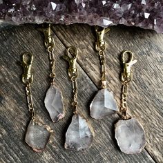 three pieces of jewelry sitting on top of a wooden table