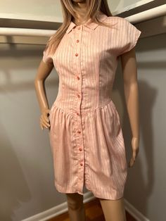 "Vintage pink dress. Buttons up front. Best for an XS/XXS. Length 33\" Best for 24-25\" waist  Pit to pit 17\" All measurements of items listed are approximate, and are taken as accurately as I can to the best of my ability. Please note that with vintage items, there may be signs of wear and small imperfections. When possible, we will show imperfections and the price will reflect these. If you have any questions, or would like to see more pictures, please don't hesitate to reach out." Vintage Pink Dress, Dress Buttons, Textured Dress, Kansas City Mo, Dresses Xs, Vintage Pink, Kansas City, Pink Dress, Kansas