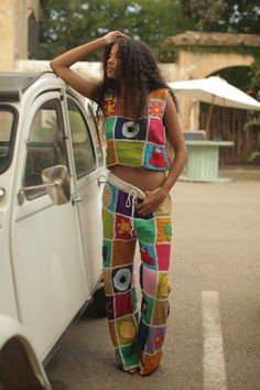 a woman standing next to a white car