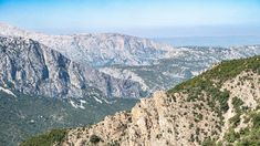 the mountains are covered in snow and green trees, with no one on top or below them