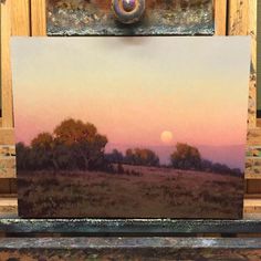 an oil painting of a sunset over a field with trees in the foreground and a full moon in the background